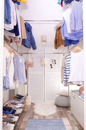 Modern dressing room with different stylish clothes and accessories