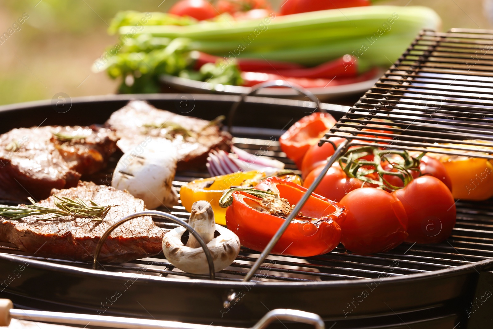 Photo of Modern grill with meat and vegetables outdoors, closeup