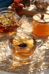 Photo of Aromatic herbal tea with anise star and honey on table