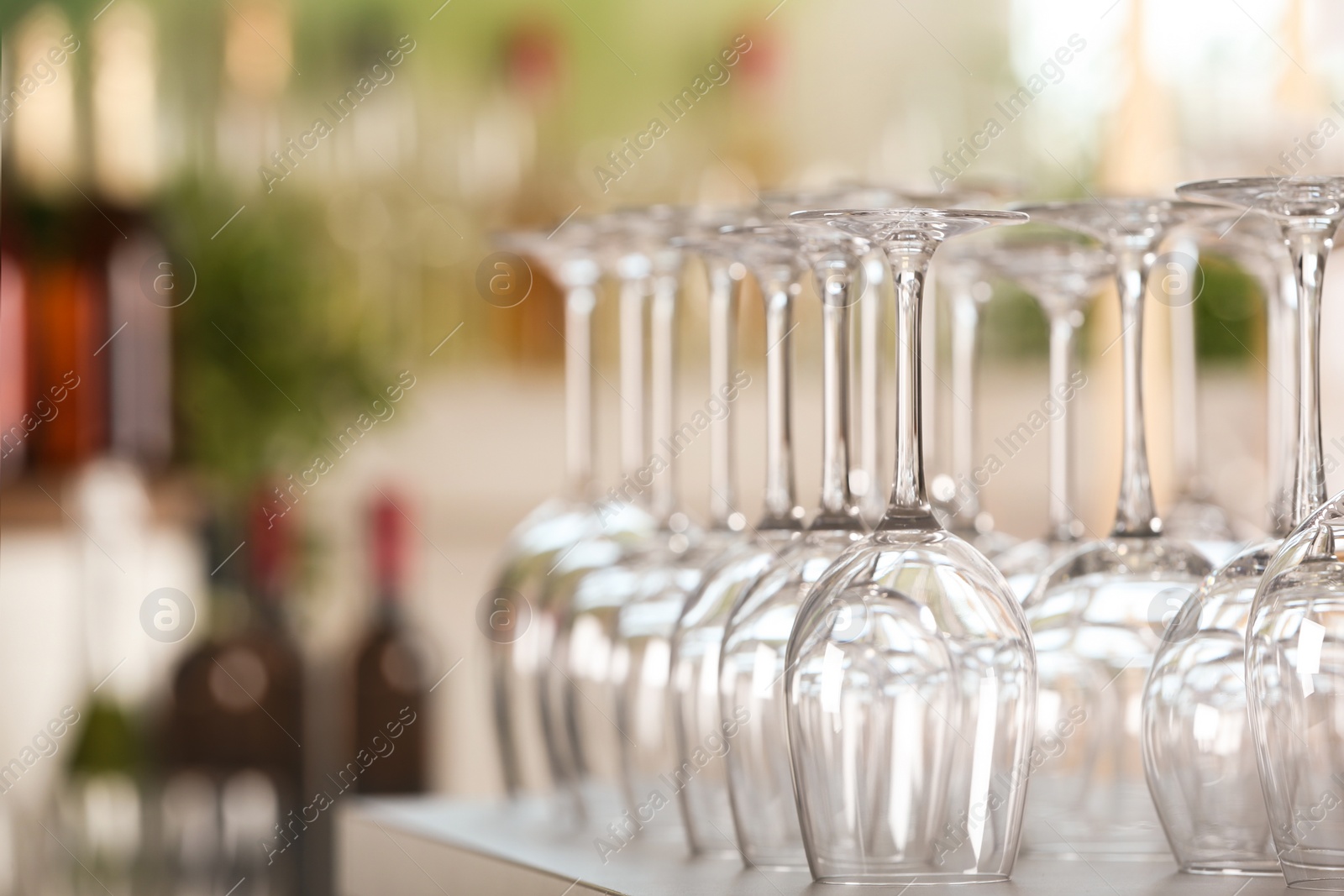 Photo of Empty glasses on table against blurred background