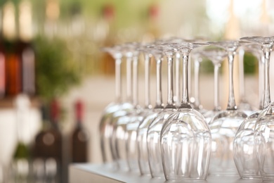 Photo of Empty glasses on table against blurred background