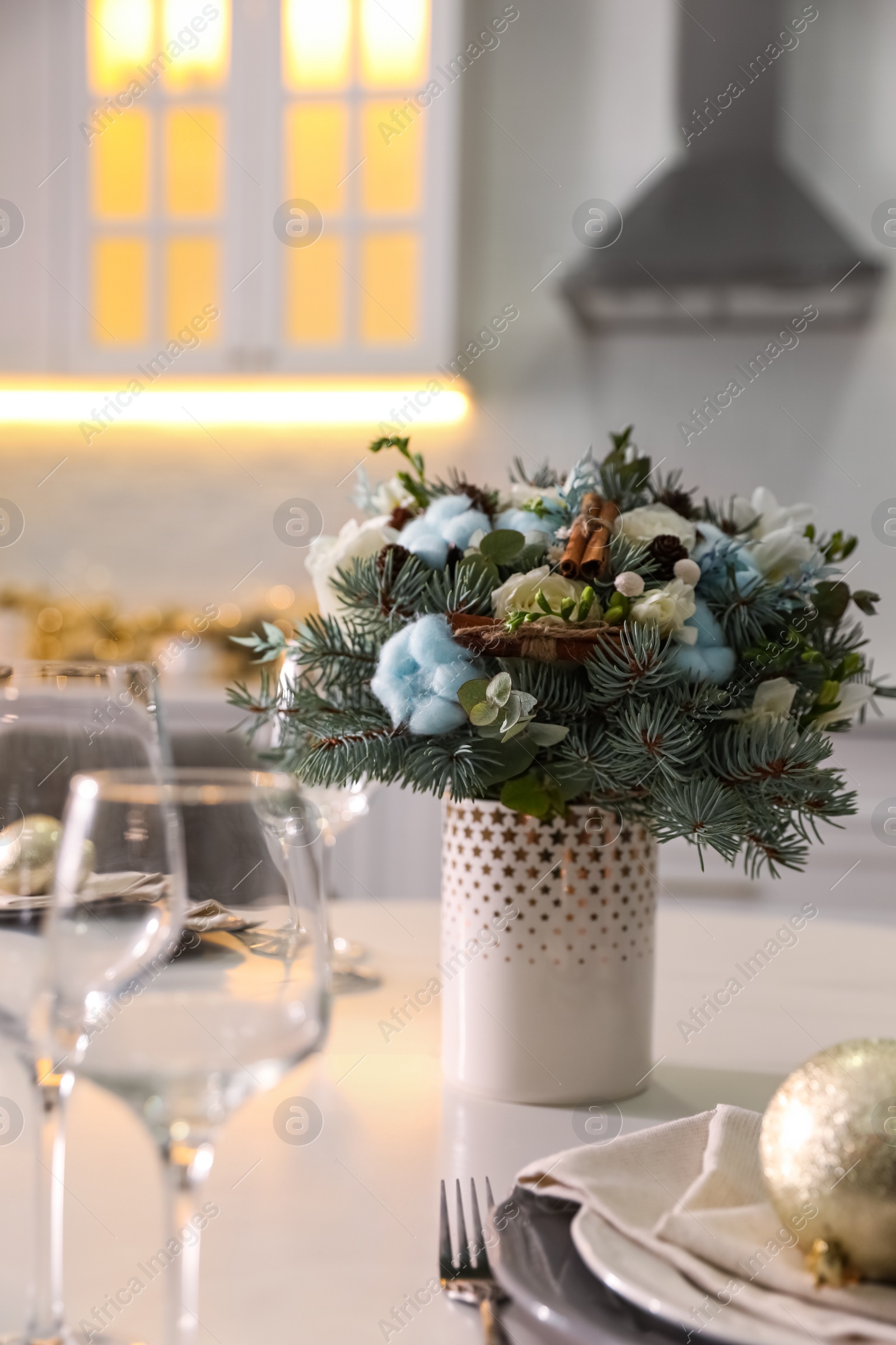 Photo of Beautiful winter bouquet on white table in kitchen
