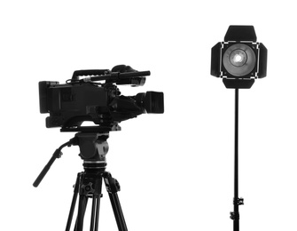 Photo of Professional video camera and lighting equipment isolated on white