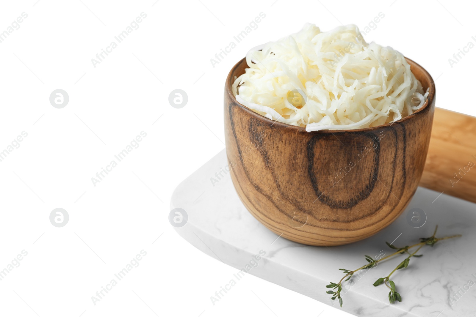 Photo of Wooden bowl of tasty fermented cabbage on white table. Space for text