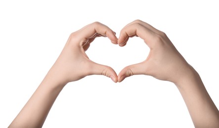 Woman making heart with her hands against white background, closeup