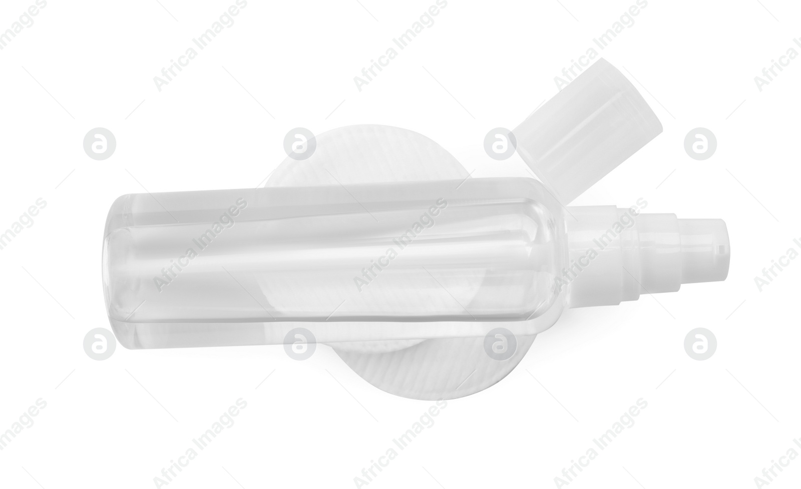 Photo of Bottle of micellar cleansing water and cotton pads on white background, top view