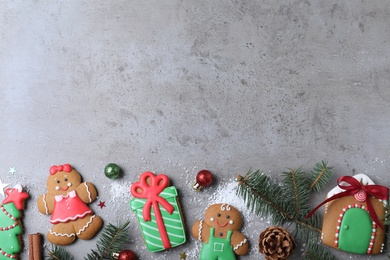 Photo of Decorated Christmas cookies on grey table, flat lay. Space for text