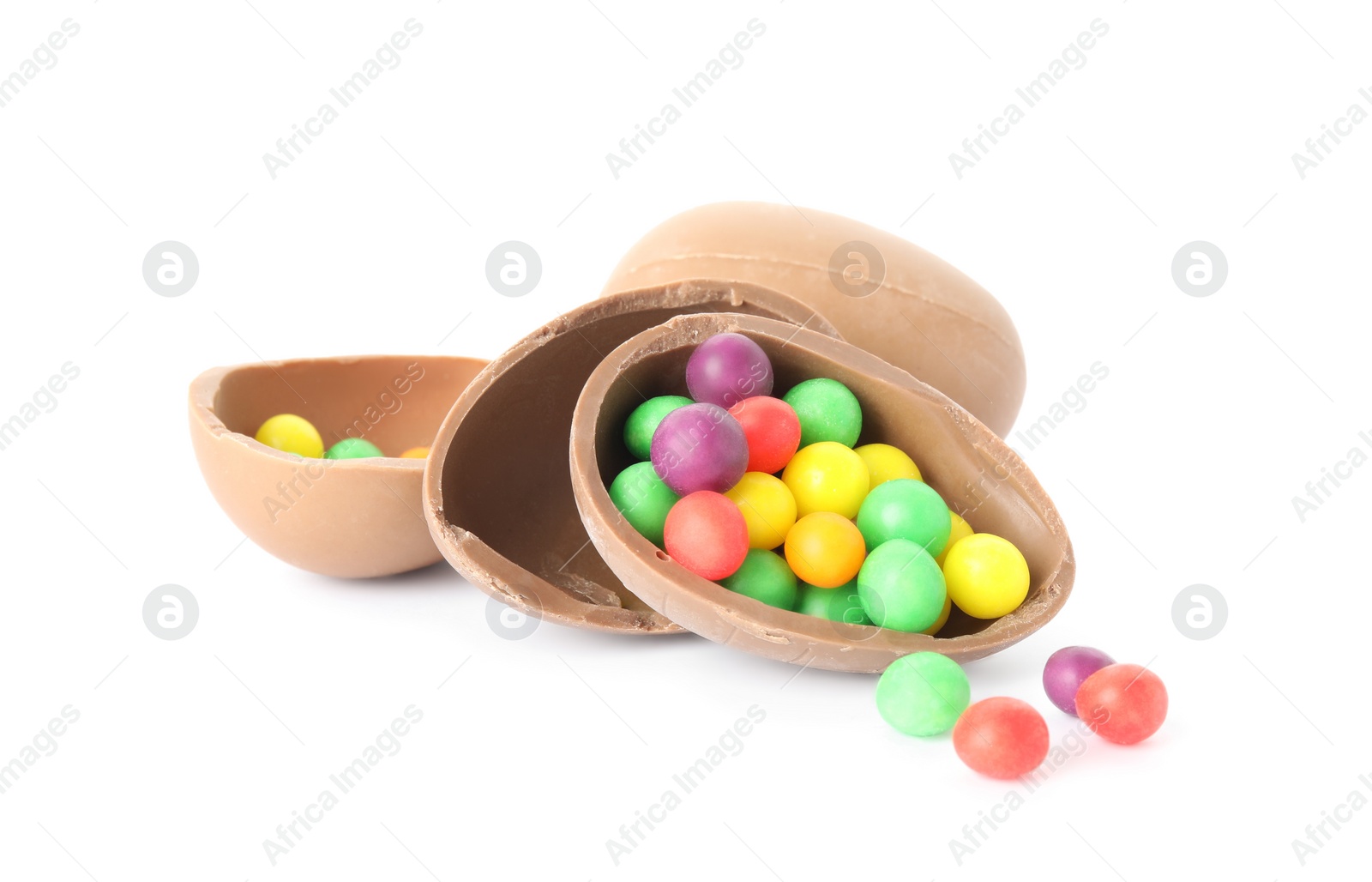 Photo of Tasty chocolate eggs with colorful candies on white background