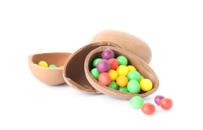 Photo of Tasty chocolate eggs with colorful candies on white background