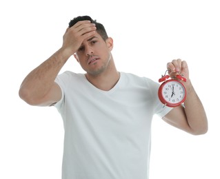 Photo of Emotional man with alarm clock on white background. Being late because of oversleeping