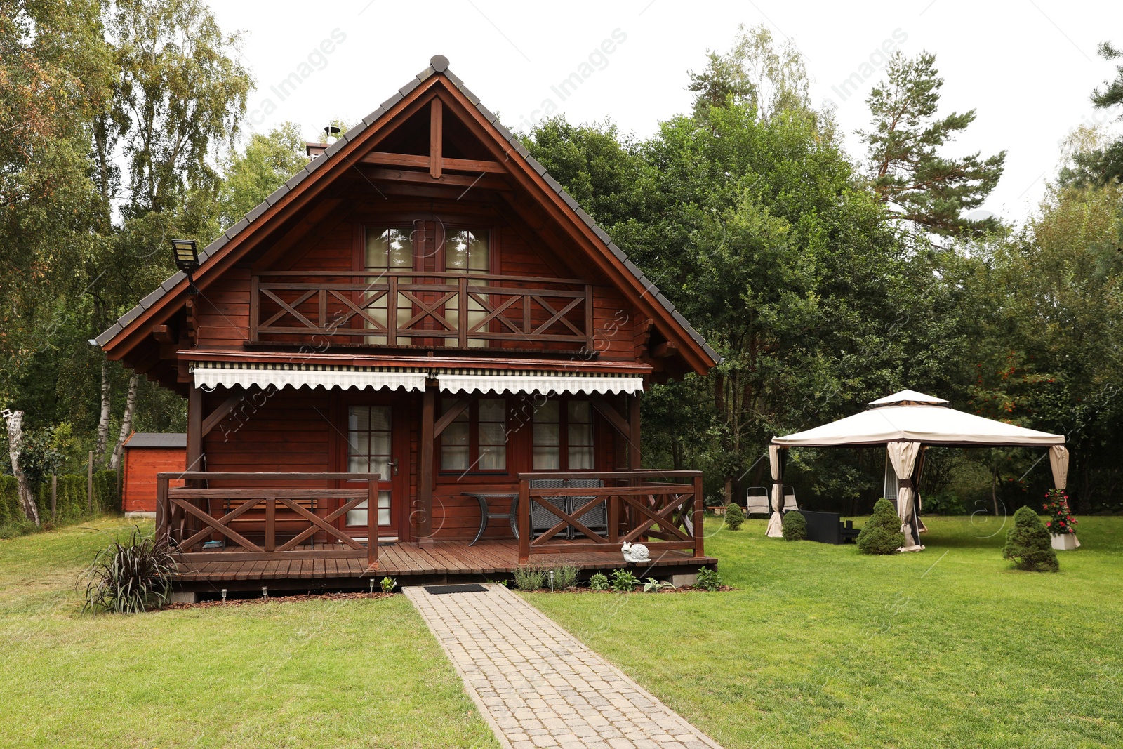 Photo of Exterior of beautiful wooden summer house with porch