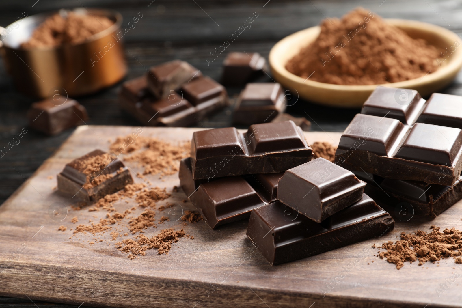 Photo of Pieces of black chocolate on wooden board