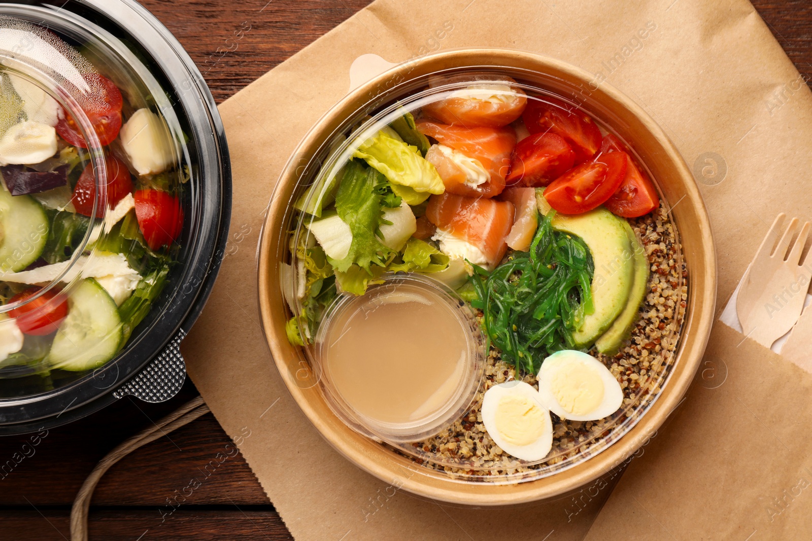 Photo of Tasty food in containers on wooden table, flat lay