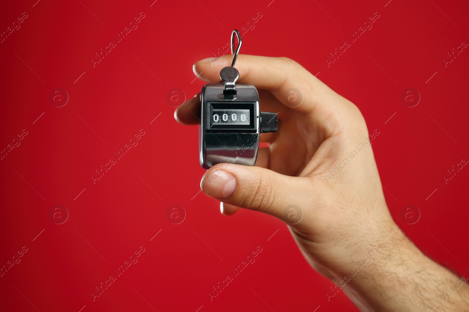 Photo of Man modern digital timer on red background, closeup