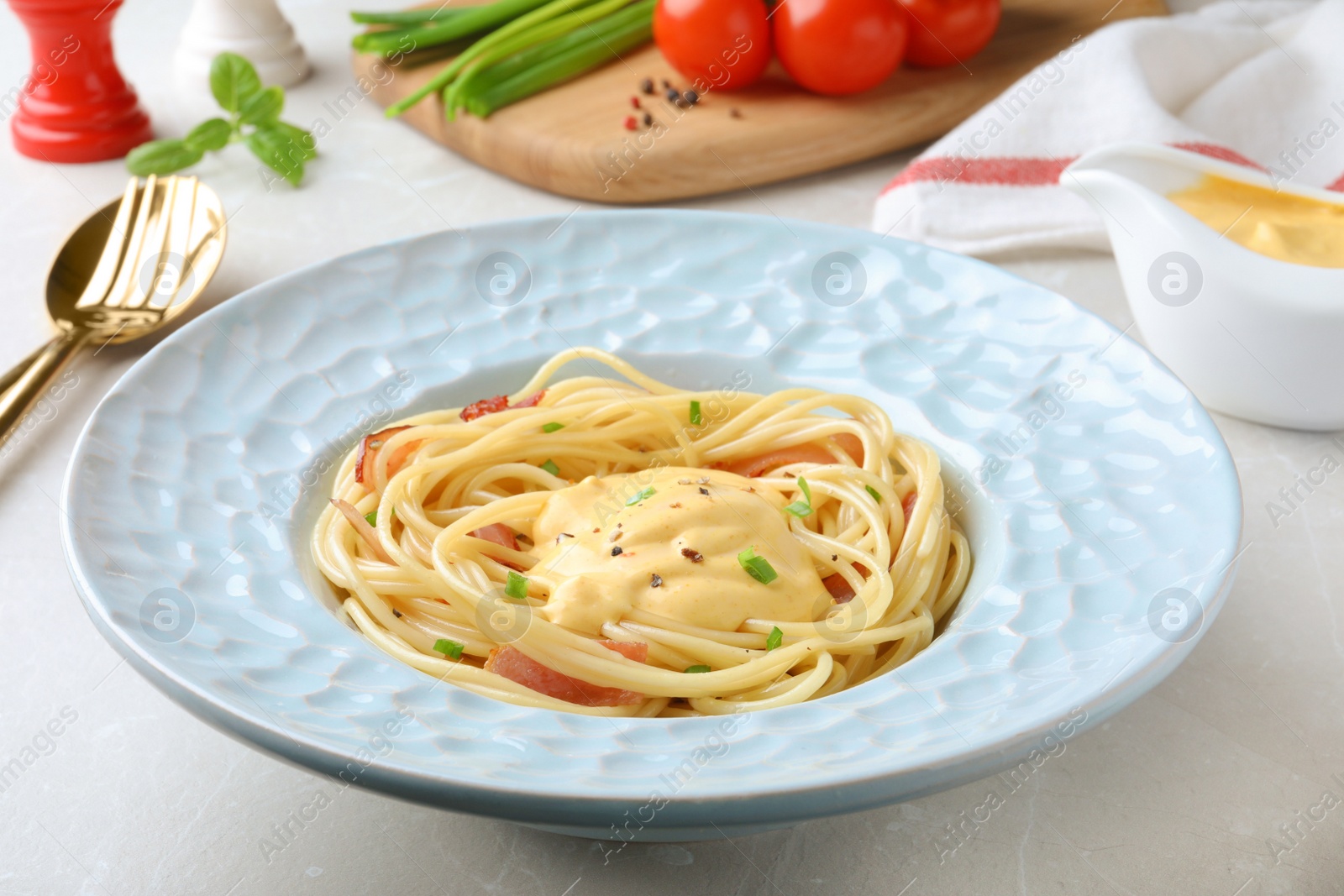 Photo of Delicious spaghetti with meat and cheese sauce on light grey table