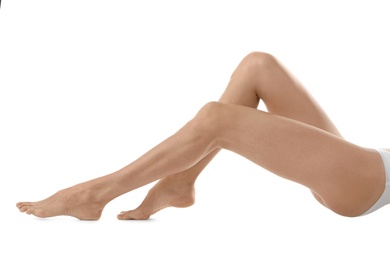 Young woman with beautiful long legs on white background, closeup