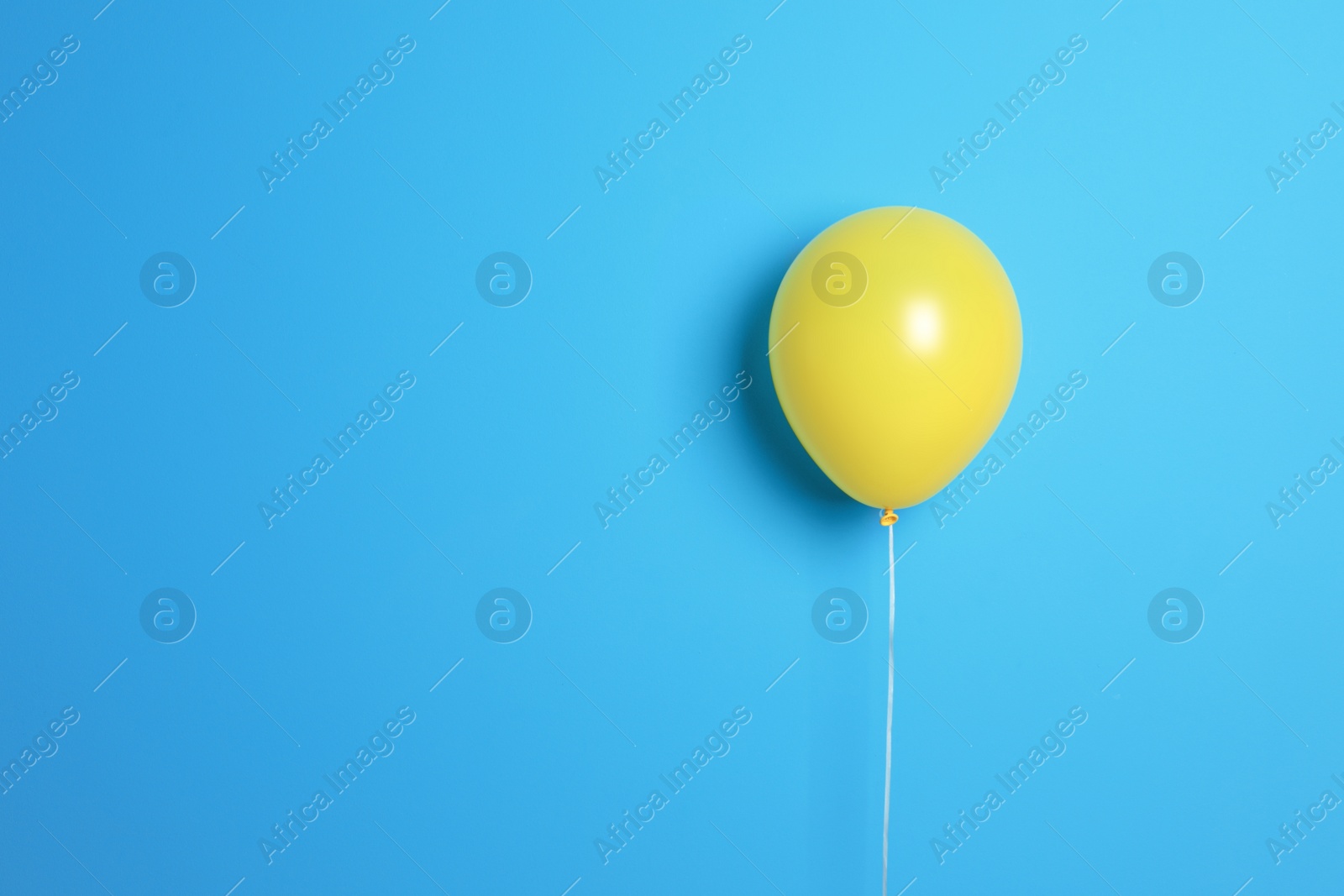 Photo of Yellow balloon on color background. Celebration time