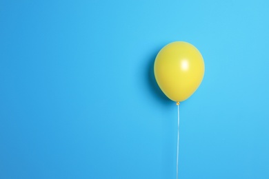 Yellow balloon on color background. Celebration time