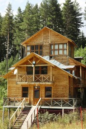 Photo of Beautiful wooden cottage with balcony near forest