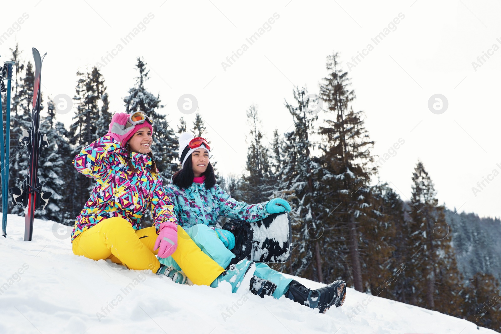 Photo of Friends with equipment on snowy hill. Winter vacation