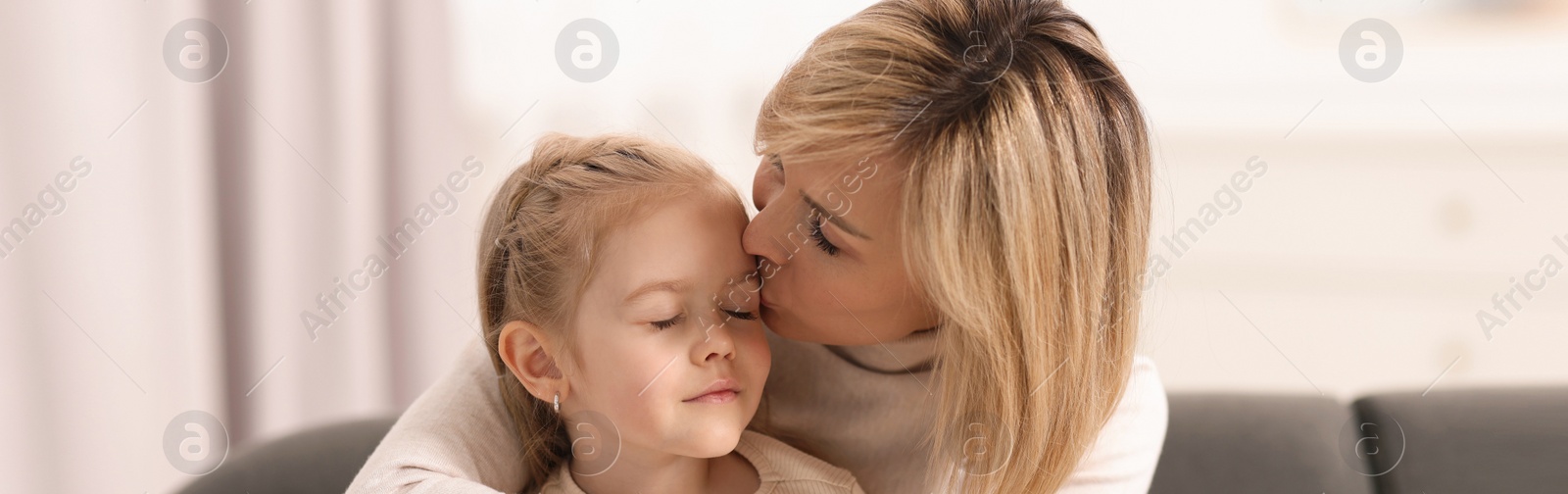 Image of Mother and her little daughter spending time together at home, banner design