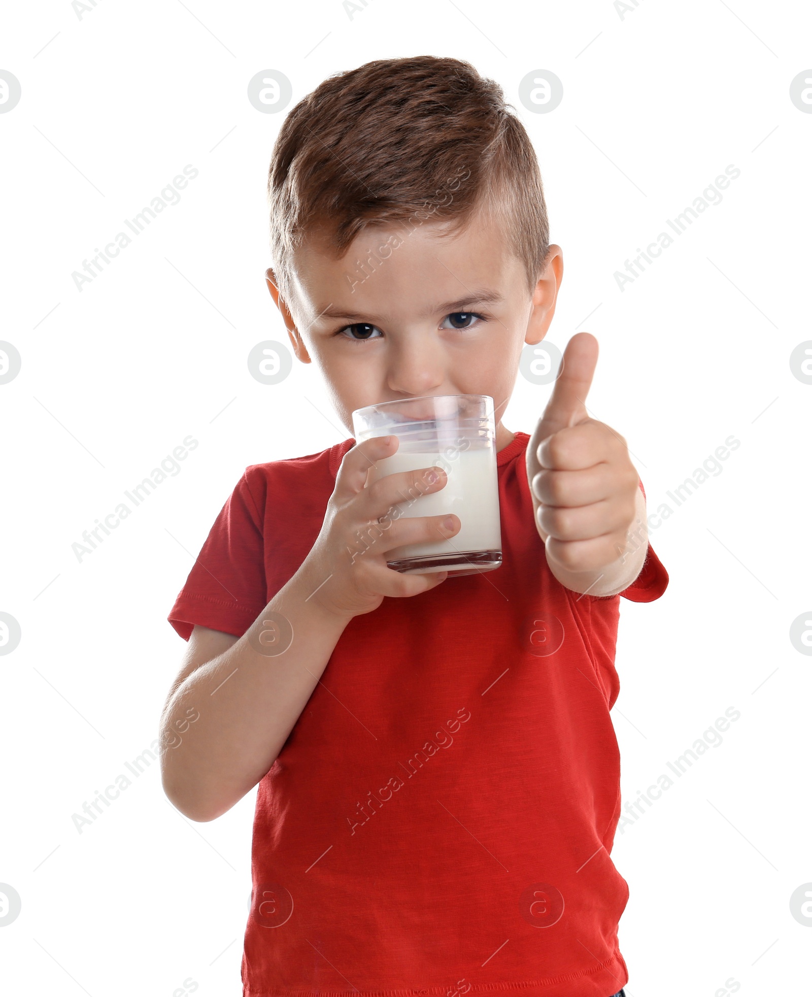 Photo of Cute little boy drinking milk on white background