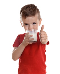 Photo of Cute little boy drinking milk on white background