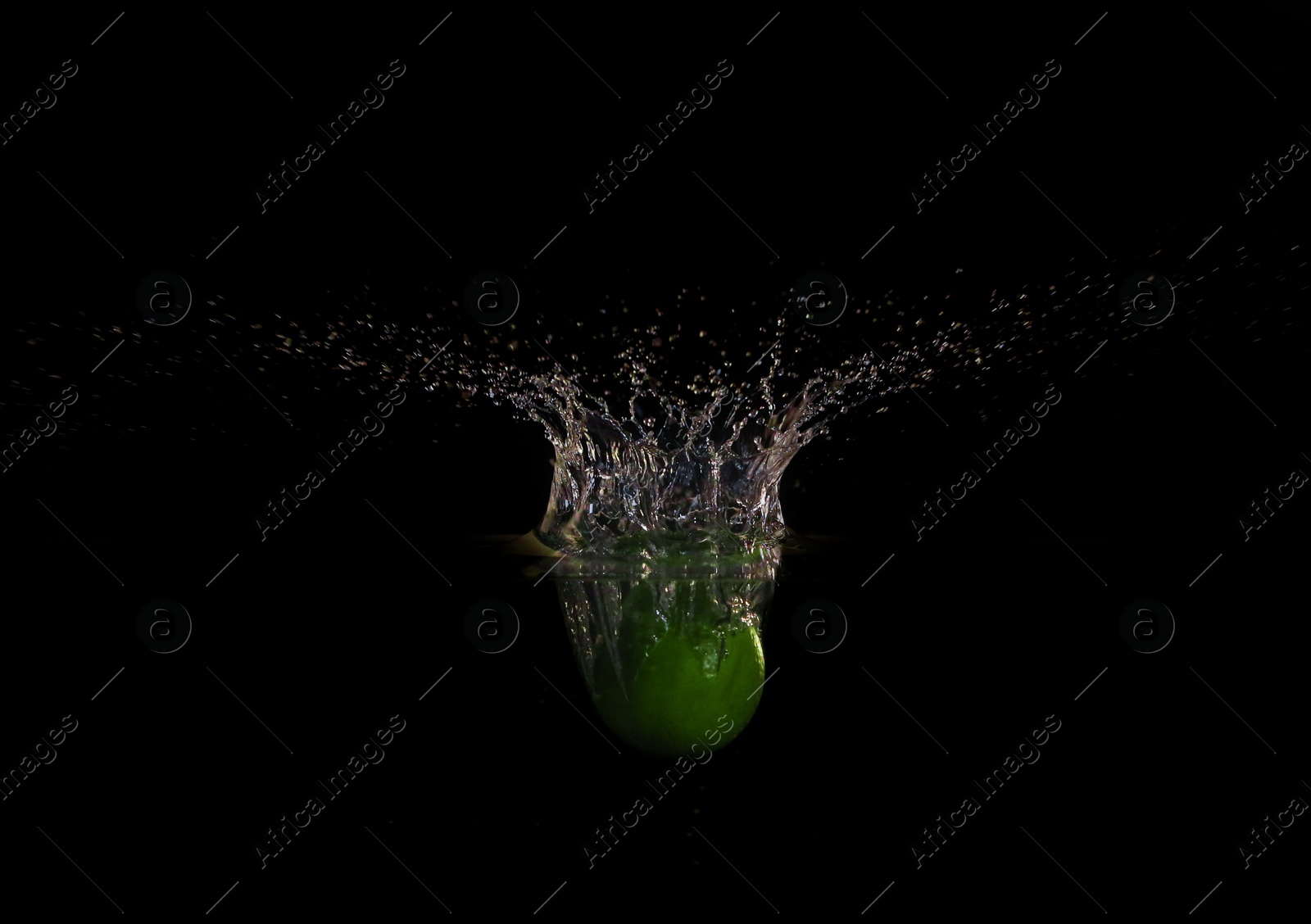 Photo of Apple falling down into clear water against black background