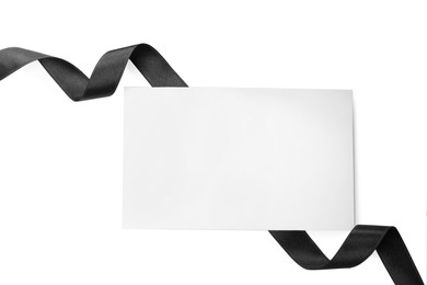 Photo of Black satin ribbon and blank card on white background, top view. Space for design