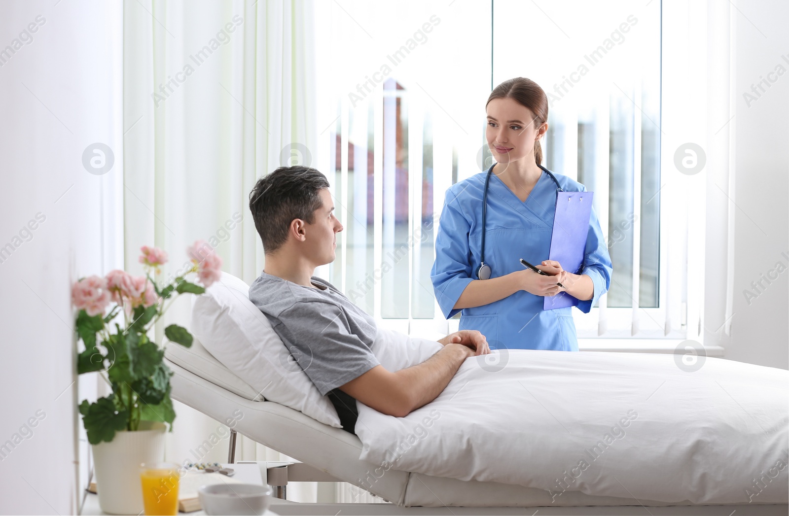 Photo of Doctor visiting her patient in hospital ward