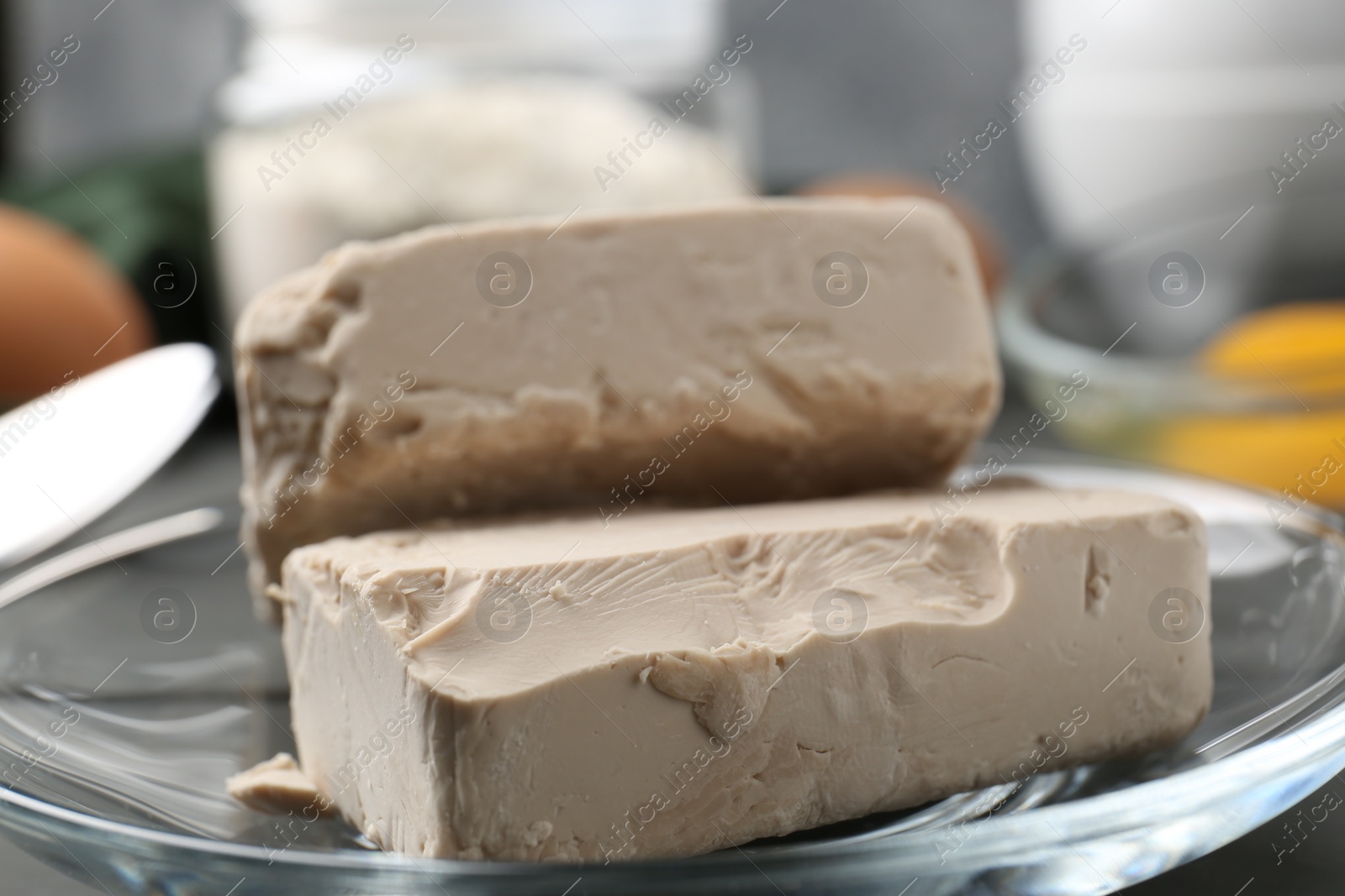 Photo of Fresh compressed yeast on grey table, closeup