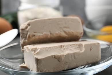 Photo of Fresh compressed yeast on grey table, closeup