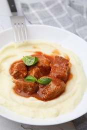 Photo of Delicious goulash served with mashed potato on table, closeup