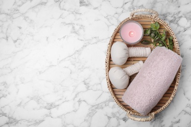 Photo of Tray with spa accessories on white marble marble background, flat lay. Space for text