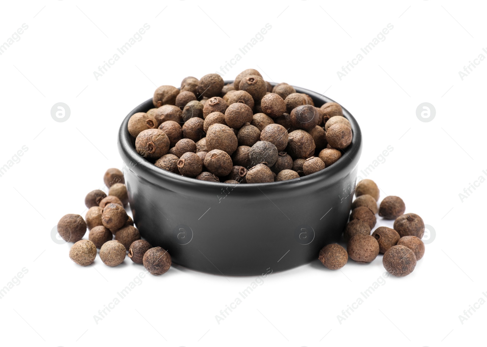 Photo of Dry allspice berries (Jamaica pepper) in bowl isolated on white