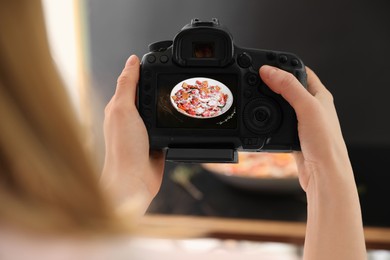 Food stylist taking photo of delicious salad with prosciutto in studio, closeup
