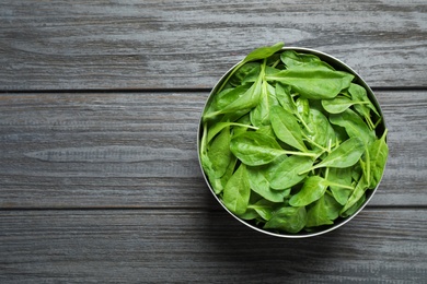 Photo of Fresh green healthy spinach on dark wooden table, top view. Space for text