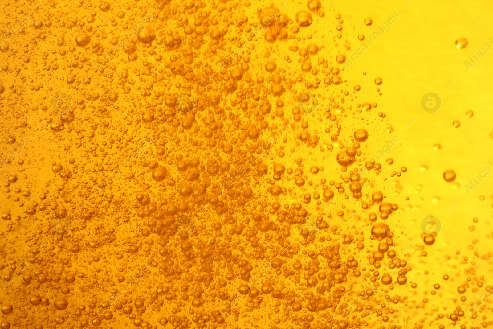 Photo of Tasty beer with bubbles as background, closeup