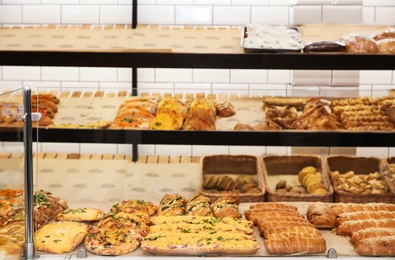 Photo of Fresh pastries on counter in bakery store