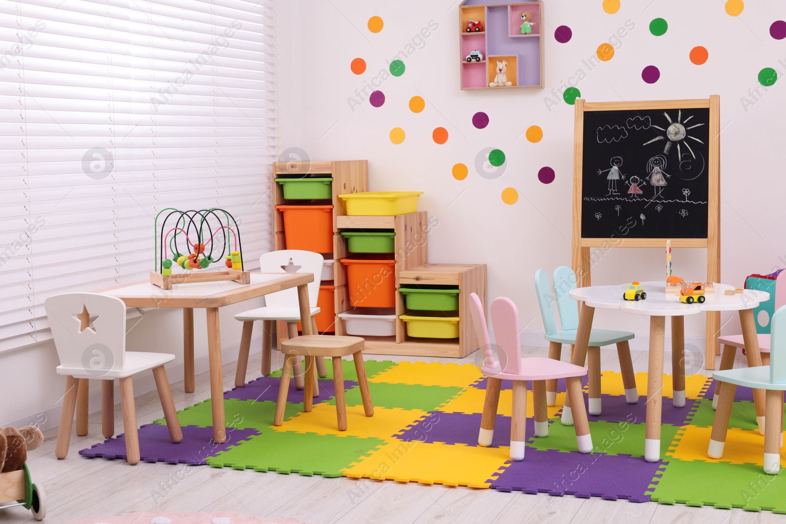 Photo of Stylish kindergarten interior with toys and modern furniture