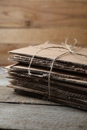 Stack of waste paper on wooden table, closeup