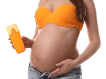 Young pregnant woman with sun protection spray on white background, closeup