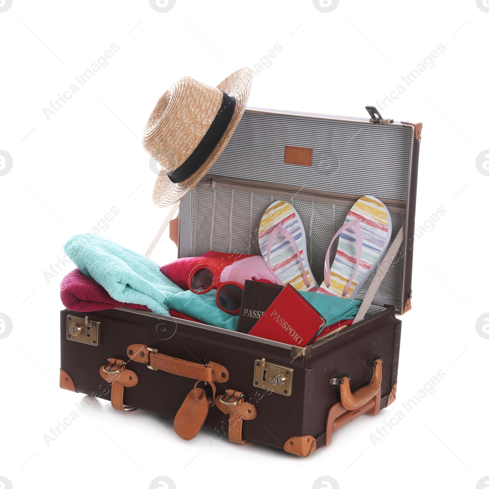 Photo of Open vintage suitcase with clothes packed for summer vacation isolated on white