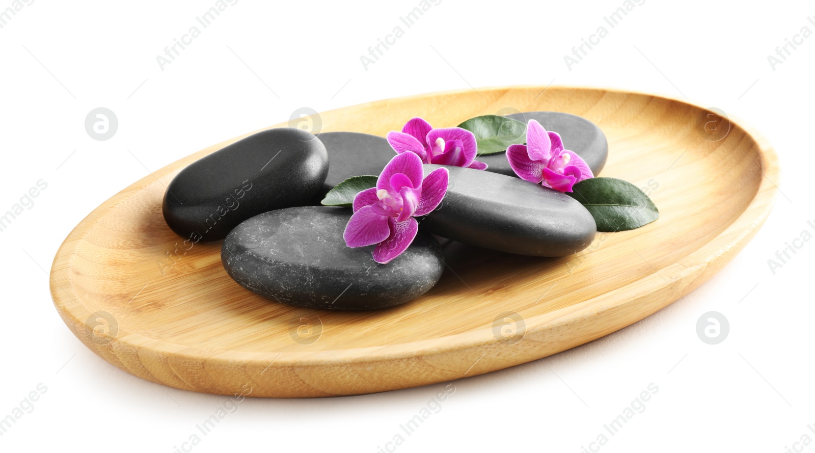 Photo of Wooden tray with spa stones and orchid flowers on white background