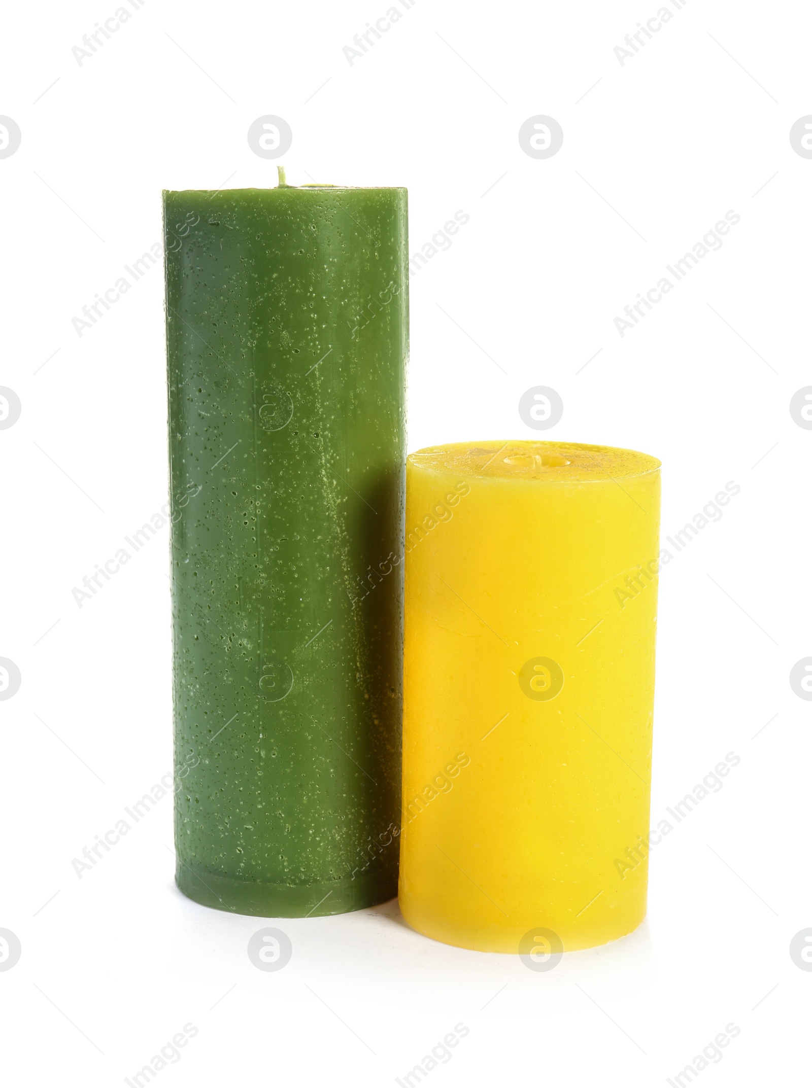 Photo of Two decorative wax candles on white background