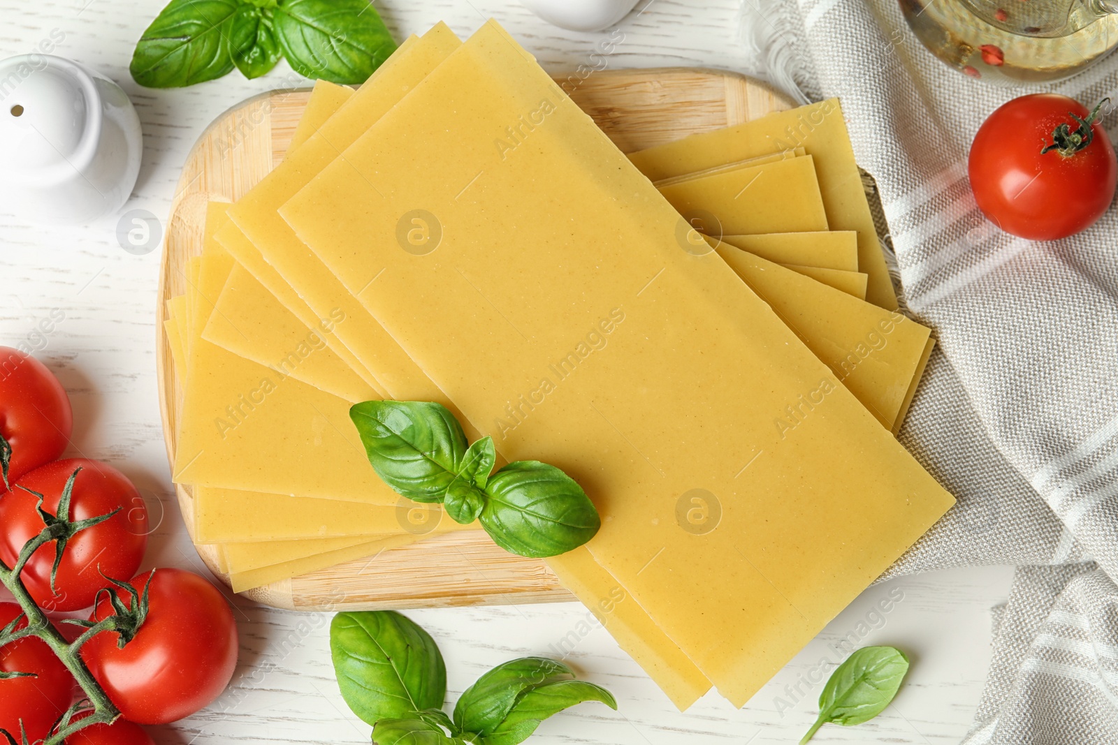 Photo of Flat lay composition with uncooked lasagna sheets on white wooden table