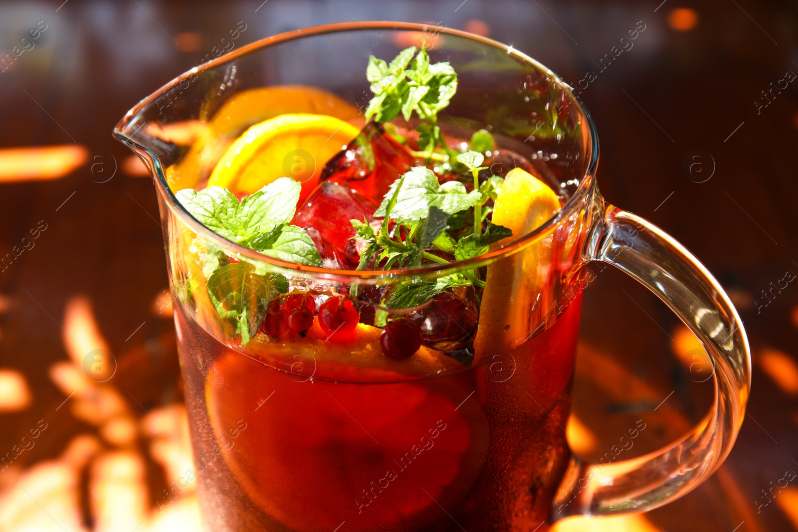 Photo of Jug with delicious refreshing cocktail, closeup