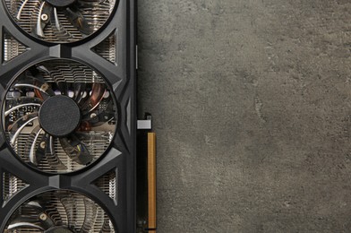 Photo of One computer graphics card on grey textured table, top view. Space for text