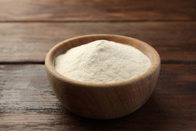 Bowl of agar-agar powder on wooden table, closeup