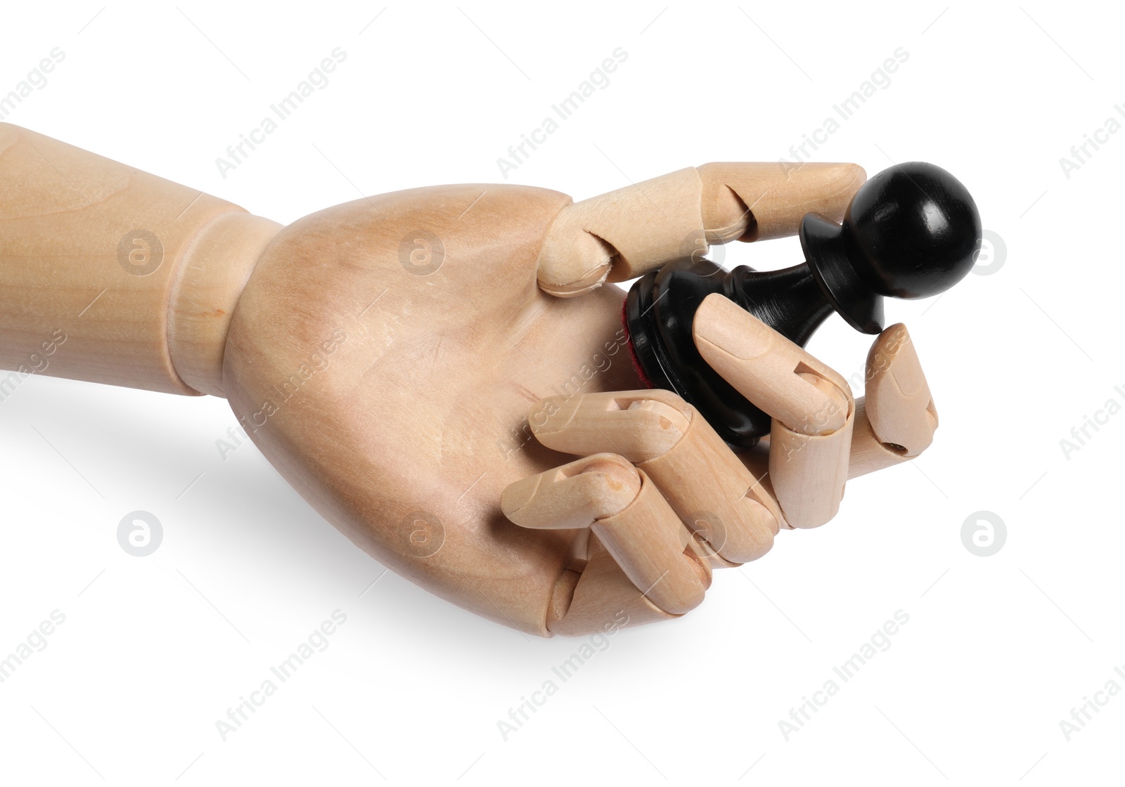 Photo of Robot with black chess piece isolated on white. Wooden hand representing artificial intelligence